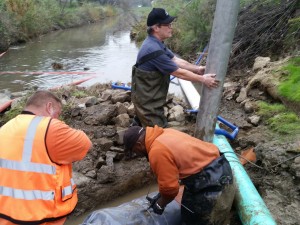 Kevin Cullen repairing pipe crossing