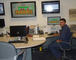 FSSD's Ben Carver sitting in front of plant monitoring screens at the operations center