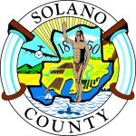 Solano county logo. a life saver surrounds the image of a native american man on the edge of the water and a sunny landscape